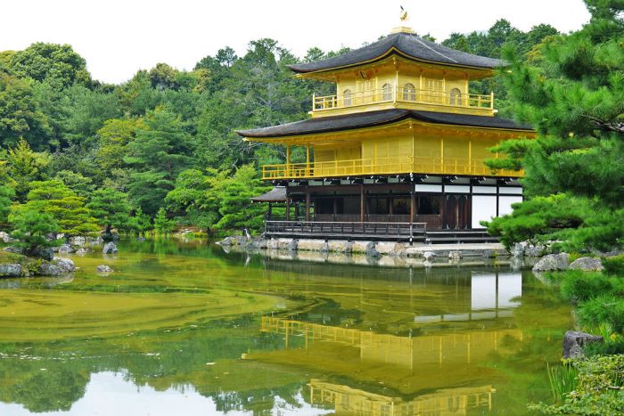 Kinkakuji Temple (Rokuonji Temple) or the "Golden Pavilion," reflects beautifully in the waters of the Kyōko-chi Pond, a "mirror pond"  surrounded by its garden in Kyoto, Japan. 